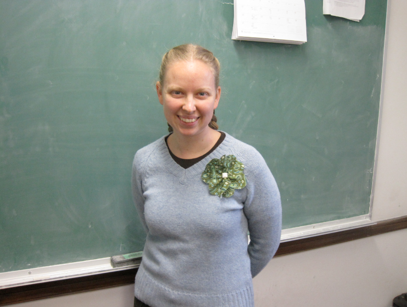 Dr. Evelyn Lamb posing in front of a blackboard